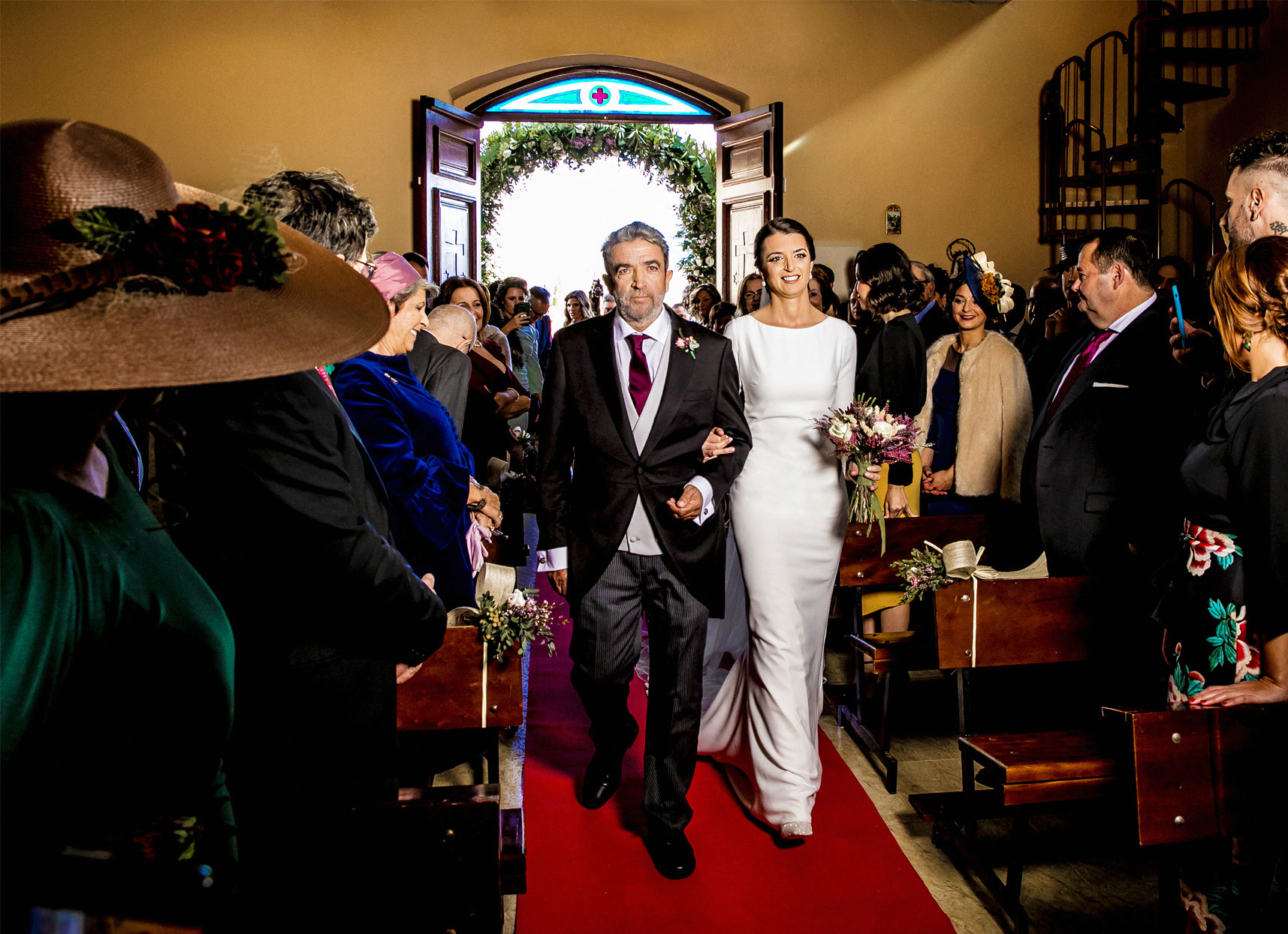 La novia entrando a la iglesia del brazo de su padre.